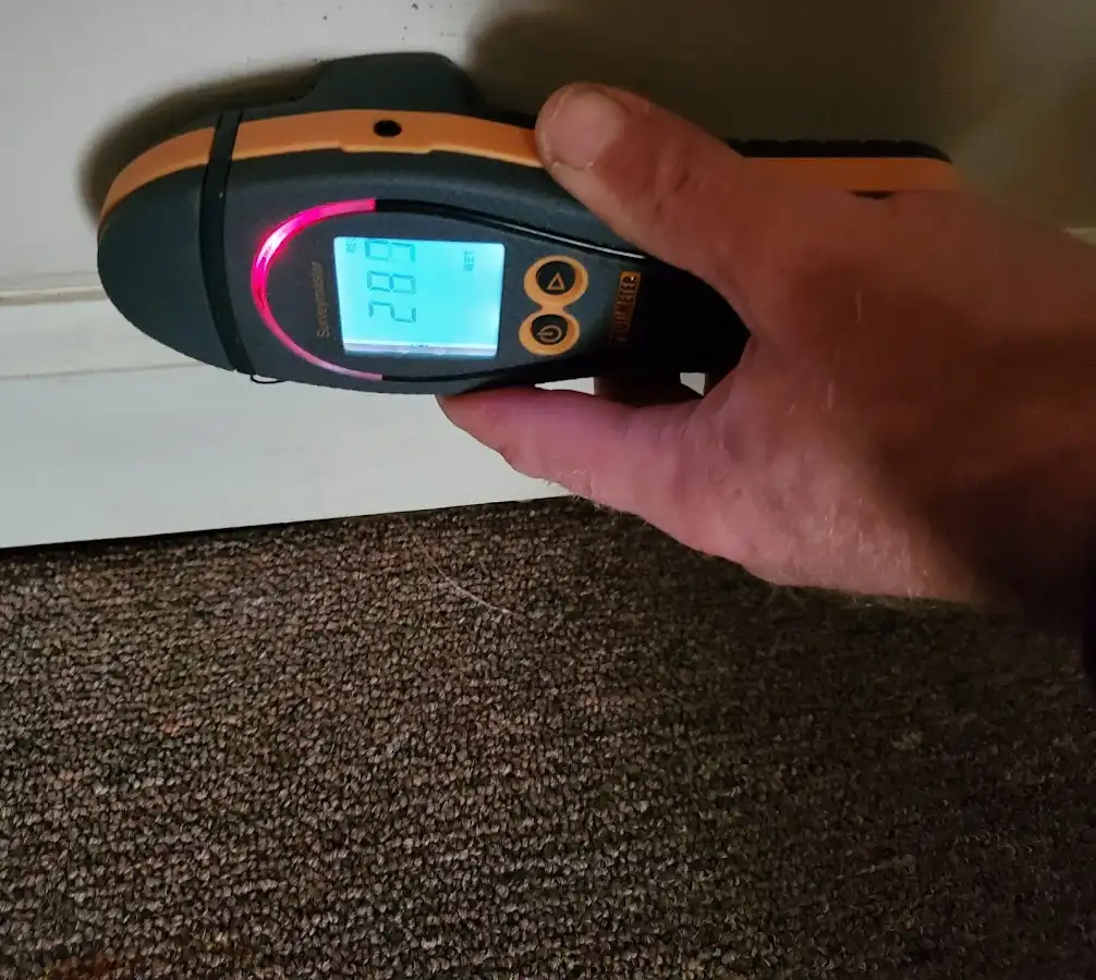 Moisture detection at baseboard during Storm Damage Restoration in Johnstown